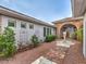 Charming front yard with decorative metal art, stone pathway, mature trees, and manicured greenery at 3 Pine Hollow Dr, Henderson, NV 89052