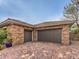 Three car attached garage featuring stone veneer, concrete tile roofing and stamped concrete driveway at 3 Pine Hollow Dr, Henderson, NV 89052