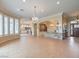 Open living room featuring a chandelier, large windows, and tile flooring at 3 Pine Hollow Dr, Henderson, NV 89052