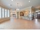 Spacious living room with tile floors, large windows, and elegant chandelier lighting at 3 Pine Hollow Dr, Henderson, NV 89052