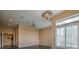 Bright living room with hardwood floors, ceiling fan, a colorful chandelier, and large windows with shutter blinds at 3 Pine Hollow Dr, Henderson, NV 89052