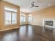 Large living room boasts hardwood floors, fireplace, and natural light from shuttered windows at 3 Pine Hollow Dr, Henderson, NV 89052