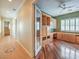 Home office with hardwood floors, and custom cabinetry and shelving; view to hallway at 3 Pine Hollow Dr, Henderson, NV 89052