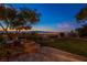 Inviting backyard with a stone fireplace and cozy seating area, perfect for outdoor gatherings at 3 Pine Hollow Dr, Henderson, NV 89052