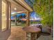 Outdoor kitchen with stone counters, a built-in grill, and a covered patio overlooking the landscaped yard at 3 Pine Hollow Dr, Henderson, NV 89052