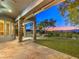 Covered outdoor patio with stone pillars, a manicured lawn, and a picturesque view of the backyard and mountains at 3 Pine Hollow Dr, Henderson, NV 89052