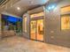 Covered patio with stone accents, providing a view of the backyard and the home's interior through sliding glass doors at 3 Pine Hollow Dr, Henderson, NV 89052