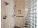 Close-up of a modern shower with glass block, tiled walls, and chrome fixtures at 3 Pine Hollow Dr, Henderson, NV 89052