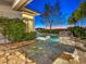 Backyard pool with rock accents and flagstone patio, providing a relaxing retreat with elegant design at 3 Pine Hollow Dr, Henderson, NV 89052