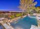 Backyard pool area with stone features and landscaping, offering relaxation and beautiful views at 3 Pine Hollow Dr, Henderson, NV 89052