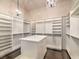 Large walk-in closet with hardwood floors, custom shelving, cabinetry and chandelier at 3 Pine Hollow Dr, Henderson, NV 89052