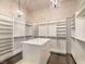 Spacious walk-in closet with custom shelving, drawers, and marble top island at 3 Pine Hollow Dr, Henderson, NV 89052