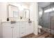 Double vanity bathroom with white cabinets, quartz countertops, and a large walk-in shower at 3105 Birdwood Dr, Las Vegas, NV 89134