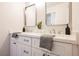 Clean bathroom with double vanity, white cabinets, quartz countertop, and large mirrors at 3105 Birdwood Dr, Las Vegas, NV 89134