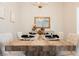 Bright dining room with a rustic wood table and modern chandelier at 3105 Birdwood Dr, Las Vegas, NV 89134