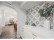 Modern entryway with white cabinets, quartz countertops, and patterned tile backsplash at 3105 Birdwood Dr, Las Vegas, NV 89134