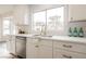 Modern white kitchen with stainless steel appliances and quartz countertops at 3105 Birdwood Dr, Las Vegas, NV 89134