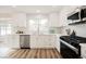 Modern white kitchen with stainless steel appliances and quartz countertops at 3105 Birdwood Dr, Las Vegas, NV 89134