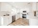 Modern white kitchen with stainless steel appliances and quartz countertops at 3105 Birdwood Dr, Las Vegas, NV 89134