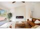 Spacious living room featuring a modern electric fireplace and leather sofas at 3105 Birdwood Dr, Las Vegas, NV 89134