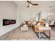 Living room with electric fireplace, leather couches, and ceiling fan at 3105 Birdwood Dr, Las Vegas, NV 89134