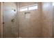 Modern shower with neutral tone tile, a niche, and a window for natural light at 3105 Birdwood Dr, Las Vegas, NV 89134