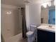 Bathroom with tub and shower, and grey curtains at 3125 N Buffalo Dr # 2120, Las Vegas, NV 89128