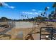 Community sandy beach area with lake access, palm trees, and lounge area at 3125 N Buffalo Dr # 2120, Las Vegas, NV 89128