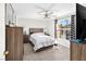 Comfortable bedroom with a queen-size bed, wood dresser, and ceiling fan at 3125 N Buffalo Dr # 2120, Las Vegas, NV 89128