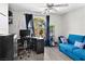 Bright bedroom featuring a functional workspace and a comfortable blue sofa bed at 3125 N Buffalo Dr # 2120, Las Vegas, NV 89128