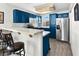 Modern kitchen with blue cabinets, white countertops, and stainless steel appliances at 3125 N Buffalo Dr # 2120, Las Vegas, NV 89128