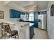 Modern kitchen with blue cabinets and stainless steel appliances at 3125 N Buffalo Dr # 2120, Las Vegas, NV 89128