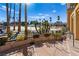 View of sandy beach pool area with palm trees and umbrellas at 3125 N Buffalo Dr # 2120, Las Vegas, NV 89128