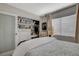 Bright bedroom with built-in shelving and a comfortable bed at 330 Shadybrook Ln # D, Las Vegas, NV 89107