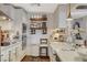 White kitchen with wood shelving and breakfast bar at 330 Shadybrook Ln # D, Las Vegas, NV 89107