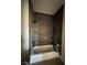 Contemporary bathroom with dark gray tile and a bathtub at 3414 Mount Charleston Dr, Pahrump, NV 89048