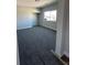 Spacious bedroom with gray carpeting and a large window at 3414 Mount Charleston Dr, Pahrump, NV 89048