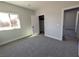 Spacious bedroom with gray carpet, large window, and walk-in closet at 3414 Mount Charleston Dr, Pahrump, NV 89048