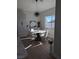 Modern dining area with a hexagonal table, white chairs and large window at 3414 Mount Charleston Dr, Pahrump, NV 89048