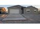 New single-story home with attached garage and paved driveway at 3414 Mount Charleston Dr, Pahrump, NV 89048