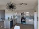 Modern kitchen with breakfast bar, stainless steel appliances, and stylish lighting at 3414 Mount Charleston Dr, Pahrump, NV 89048