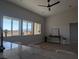 Bright living room with large windows offering scenic views and ceiling fan at 3414 Mount Charleston Dr, Pahrump, NV 89048