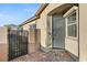 Gray front door with a welcome mat and side gate at 3484 Bradano Ln, Henderson, NV 89044