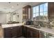 Modern kitchen with dark cabinetry, quartz countertops, and stainless steel appliances at 3484 Bradano Ln, Henderson, NV 89044