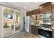 Kitchen features stainless steel appliances and sliding door to backyard patio at 3484 Bradano Ln, Henderson, NV 89044