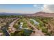 Aerial view of a luxury home community near a golf course and lake at 3514 Old Course St, Las Vegas, NV 89122