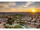 Aerial view of a residential area with a golf course and sunset at 3514 Old Course St, Las Vegas, NV 89122