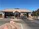 Community entrance featuring decorative rock landscaping and palm trees at 3514 Old Course St, Las Vegas, NV 89122