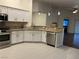 Modern kitchen with white cabinets, granite counters, and stainless steel appliances at 3514 Old Course St, Las Vegas, NV 89122