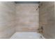 Updated bathroom with beige tile and a shower/tub combo at 3802 Terrazzo Ave, Las Vegas, NV 89115